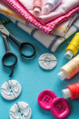 mavi arka plan üzerinde renkli dikiş ipliği