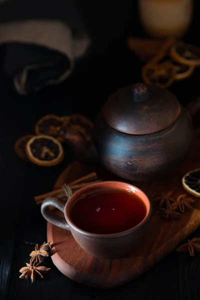 Rustic still life with black tea in a clay cup — Stock Photo, Image