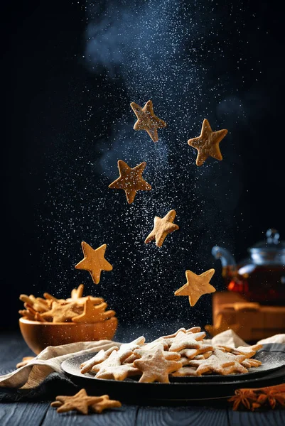 Falling stars shaped cookies with powdered sugar