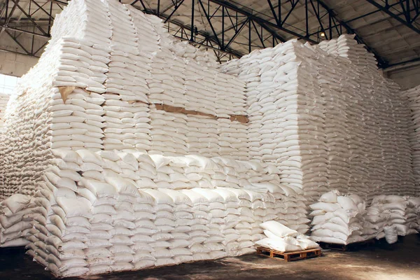 Sugar in a Warehouse. Bags of sugar. Large food warehouse with sugar sacks. Sugar beet factory