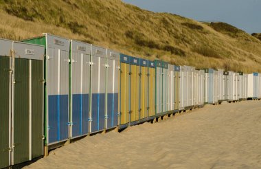 Beach huts on the beach of Zoutelande in the Netherlands, the only south orientated beach of the Netherlands clipart