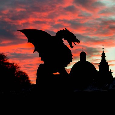 Vivid sunset sky over silhouette of Famous Dragon bridge, symbol of Ljubljana, capital of Slovenia, Europe. clipart