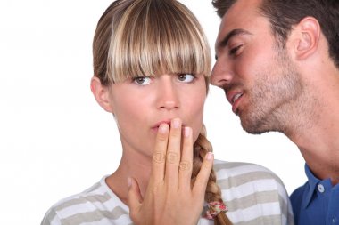 Man telling a secret to a woman clipart