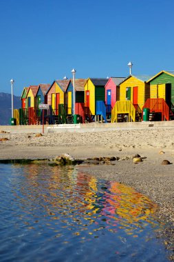 Brightly painted wooden bathing huts at St James Beach, near Cape Town, South Africa. clipart