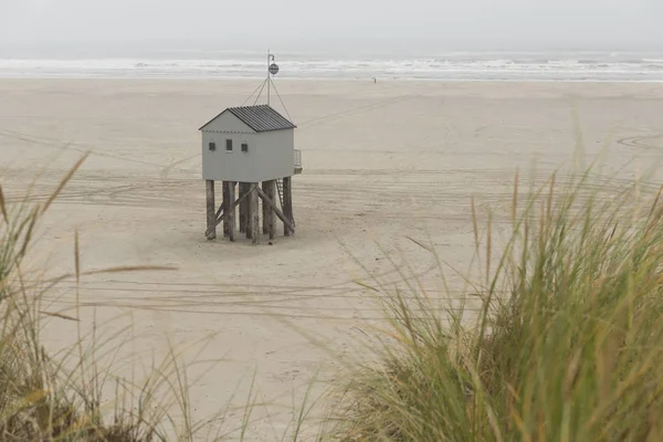 The sea cottage of Terschelling is from the end of 2015 posted near pole 24 on the North Sea Beach at the dunes on a larger and more secure distance from the North Sea on a new location. Picture was taken on a foggy and drizzly autumn day