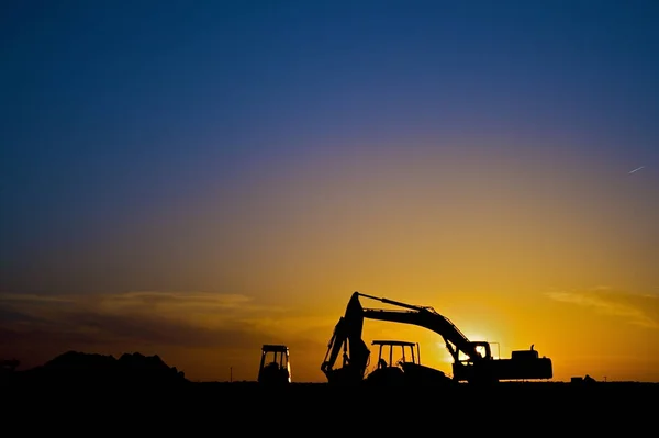 Varias Piezas Equipo Construcción Sihouetted Por Atardecer — Foto de Stock