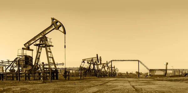 Pump Jack Group Wellheads Extraction Oil Toned — Stock Photo, Image