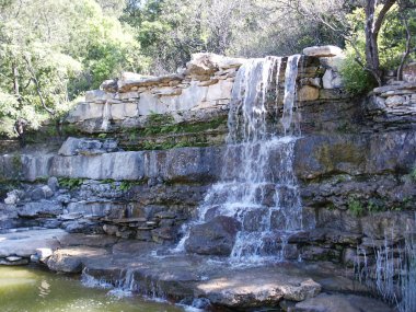 A waterfall at Zilker Park in Austin, Texas. clipart