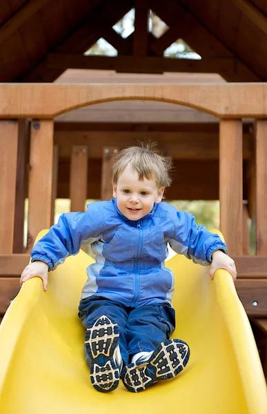 Young Boy Smiling While Sliding Sliding Board Playground — 스톡 사진