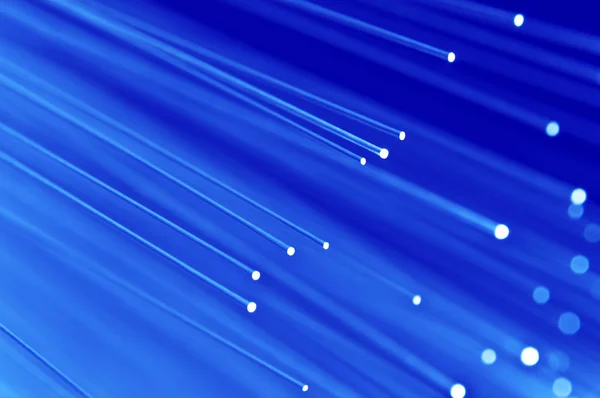 Mavi Arka Planlı Işıklı Mavi Fiber Optik Işık Iplikçiklerinin Bir — Stok fotoğraf