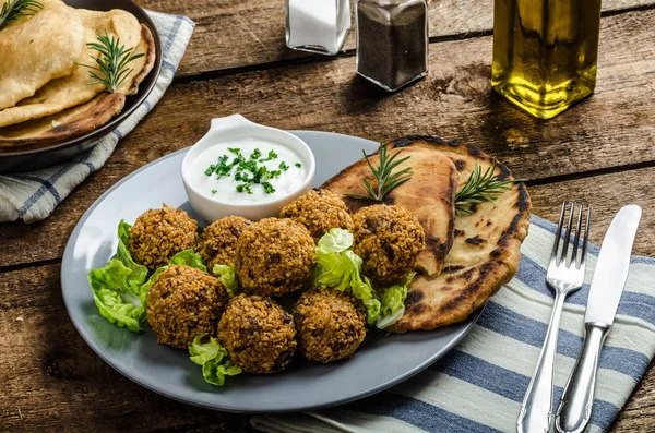 Health crunchy falafel with mint and garlic dip, naan bread with cumin and herbs