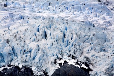 Blue Icy Portage Glacier with Black Rock Anchorage, Alaska clipart
