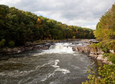 Ohiopyle in Pennsylvania on the Youghiogheny river in early fall clipart