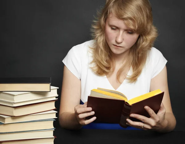 Young Woman Attentively Reads Book Dark Background — Stock Photo, Image