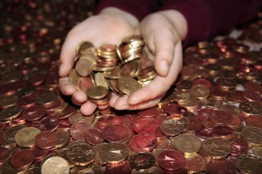 hands grabbing lots of loose change in euro cents clipart