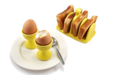 two soft boiled eggs with toast in sunshine yellow egg cups and matching toast rack clipart
