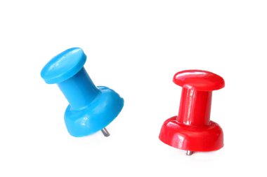 Two push pins of red and blue on a white background. clipart