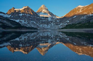 Majestic Mount Assinniboine reflected in Lake Magog in the Rocky Mountains of British Columbia, Canada clipart