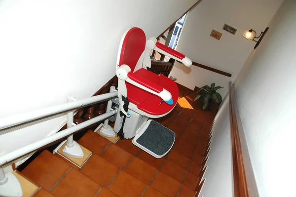 red stairlift to go up the stairs for cripple or senior