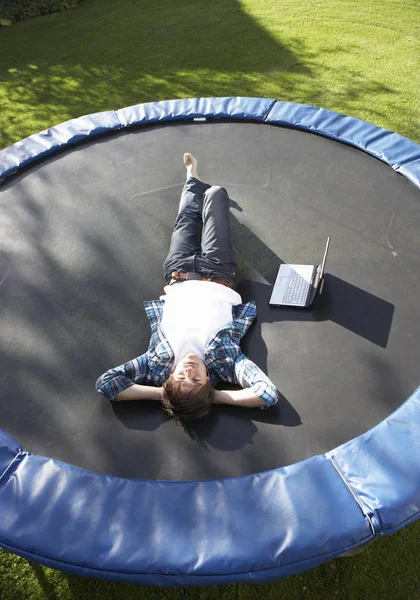 Young Man Relaxing Trampoline Laptop — Stock Photo, Image