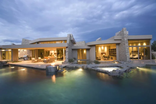 Swimming Pool And Illuminated Modern House