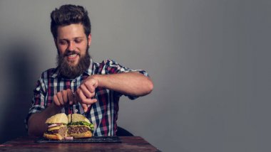 Man eating fresh self made burger close up clipart