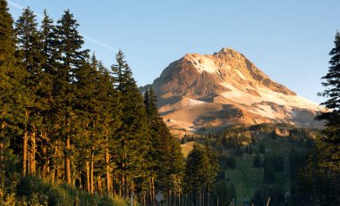 Sunrise comes to the south side of Mount Hood clipart