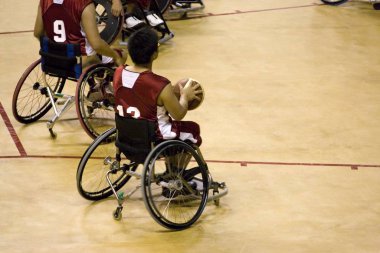 Wheel chair basketball players in action in an international tournament. clipart