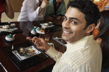 Happy Man Having Sushi clipart
