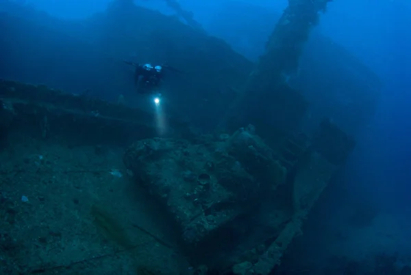 A diver hovering above a Japanese Type 97 light tank, which rests on the deck of the Nippo Maru  A Japanese cargo ship sank in during the World War 2 Operation Hailstone, February 1944, in Truk (Chuuk) Lagoon, Micronesia