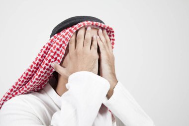 arab man covering his face clipart