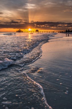 The beautiful sun setting on the shores of Fort Myers Beach located on Estero Island in Florida, United States of America clipart