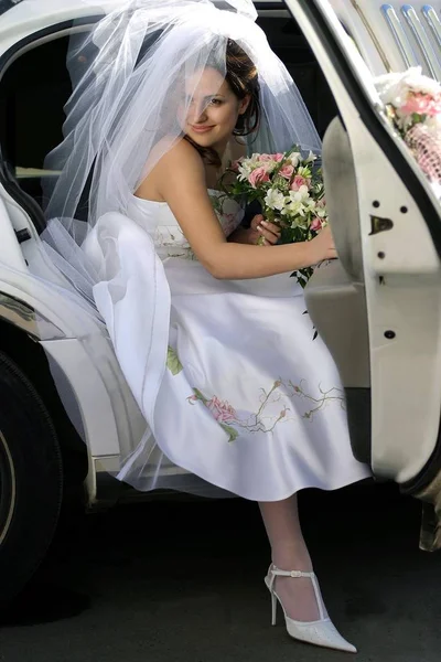 Tersenyum Pengantin Dengan Karangan Bunga Keluar Dari Pintu Mobil Pernikahan — Stok Foto