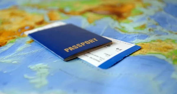 Passport and ticket  on a background map of the world. Traveling concept