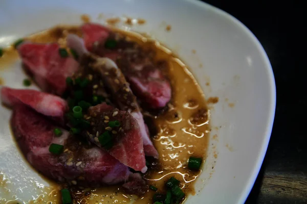 raw pork shoulder on dish. on black table Marble.