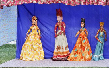 Rajasthan tribal puppet show by local tribal performers using hand crafted vividly colorful string dolls to portray historical characters, copy pace and crop margins clipart