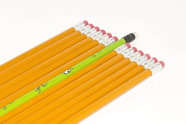 Green Pencil Sticking Out Form Crowd Plain Yellow Pencils — Stock Photo, Image