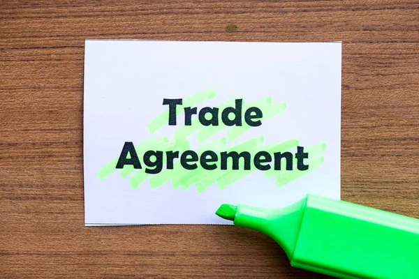 trade agreement word highlighted on the white paper