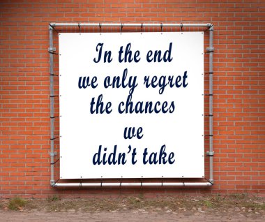 Large banner with inspirational quote on a brick wall - In the end we only regret the chances we didn't take clipart