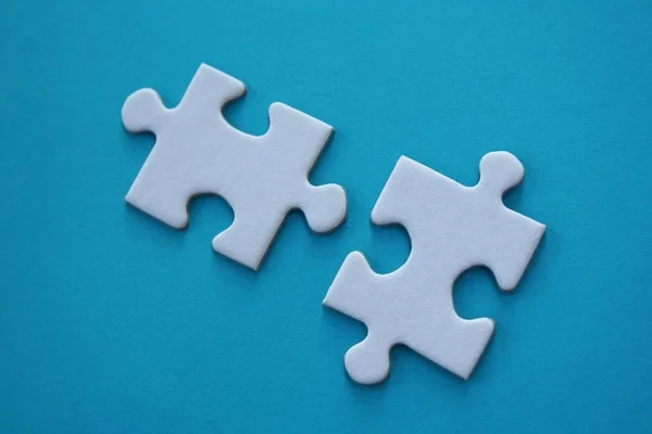 Twee Witte Puzzelstukjes Blauwe Achtergrond — Stockfoto