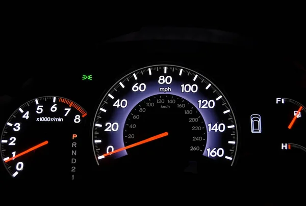 Closeup shot of an automobile odometer at night