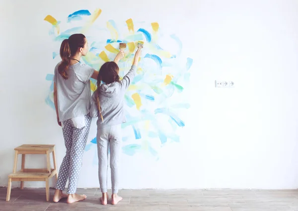 8 years old girl painting the wall at home, Instagram style toning