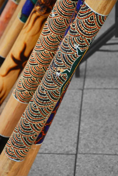 Didgeridoos lined up at an angle, displaying traditional Aboriginal culture