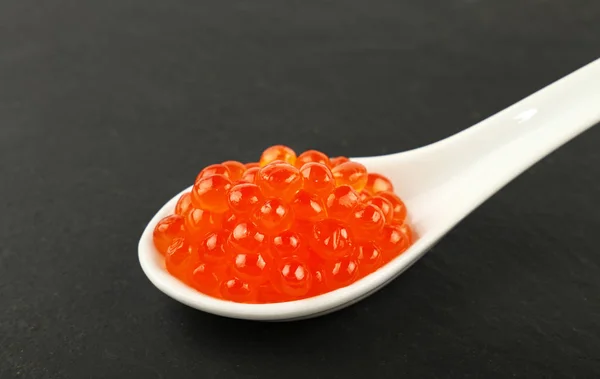 Close One Portion Salmon Fish Red Caviar White Spoon Background — Stock Photo, Image