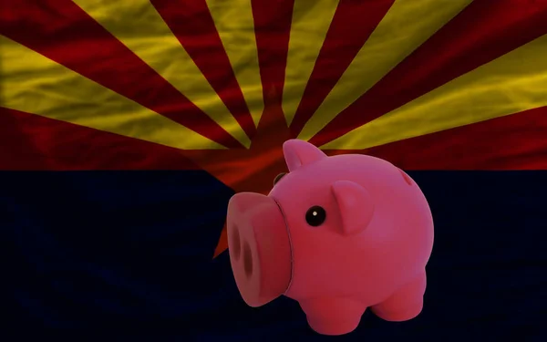 Piggy rich bank in front of flag of us state of arizona symbolizing saving and accumulating funds as good financial habit