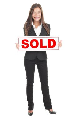Real estate agent holding sold sign. Isolated in full length on white background. Mixed caucasian / chinese model. clipart