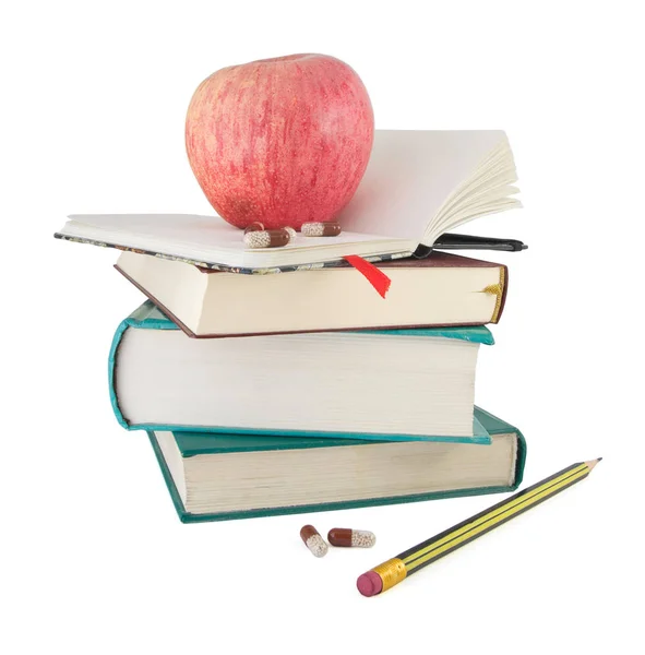 Pigułki Czerwone Jabłko Stos Podręcznika Jako Metafora Ekonomiczny Uczenia Się — Zdjęcie stockowe