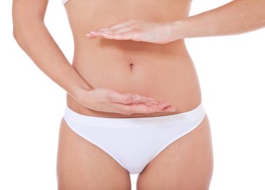 Attractive female person framing her belly. All on white background. clipart