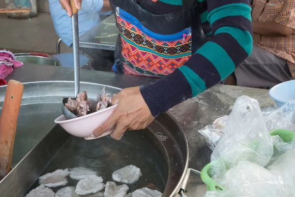 women sell noodle on the boat at traditional floating market.