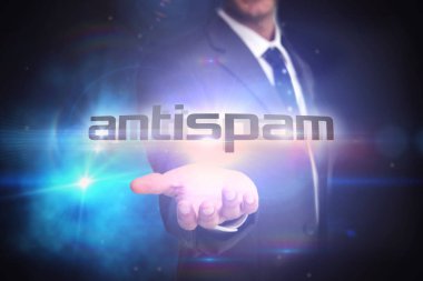 The word antispam and businessman presenting against black background with glowing light clipart